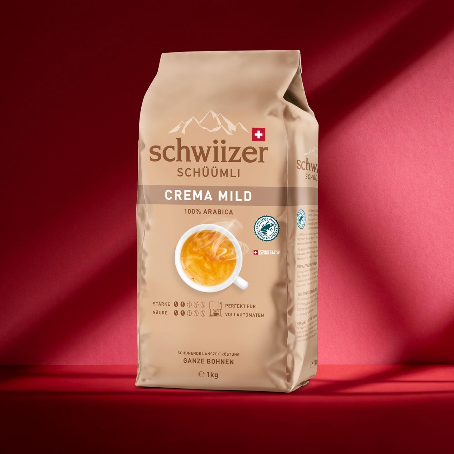 Schwiizer Schüümli Crema Mild, boabe de cafea Arabica 100% premium, fructate și cu aromă de nucă, pentru aparate de cafea complet automate, tărie 2/5, prăjire ușoară, certificat Rainforest Alliance, 1kg (pachet de 2)