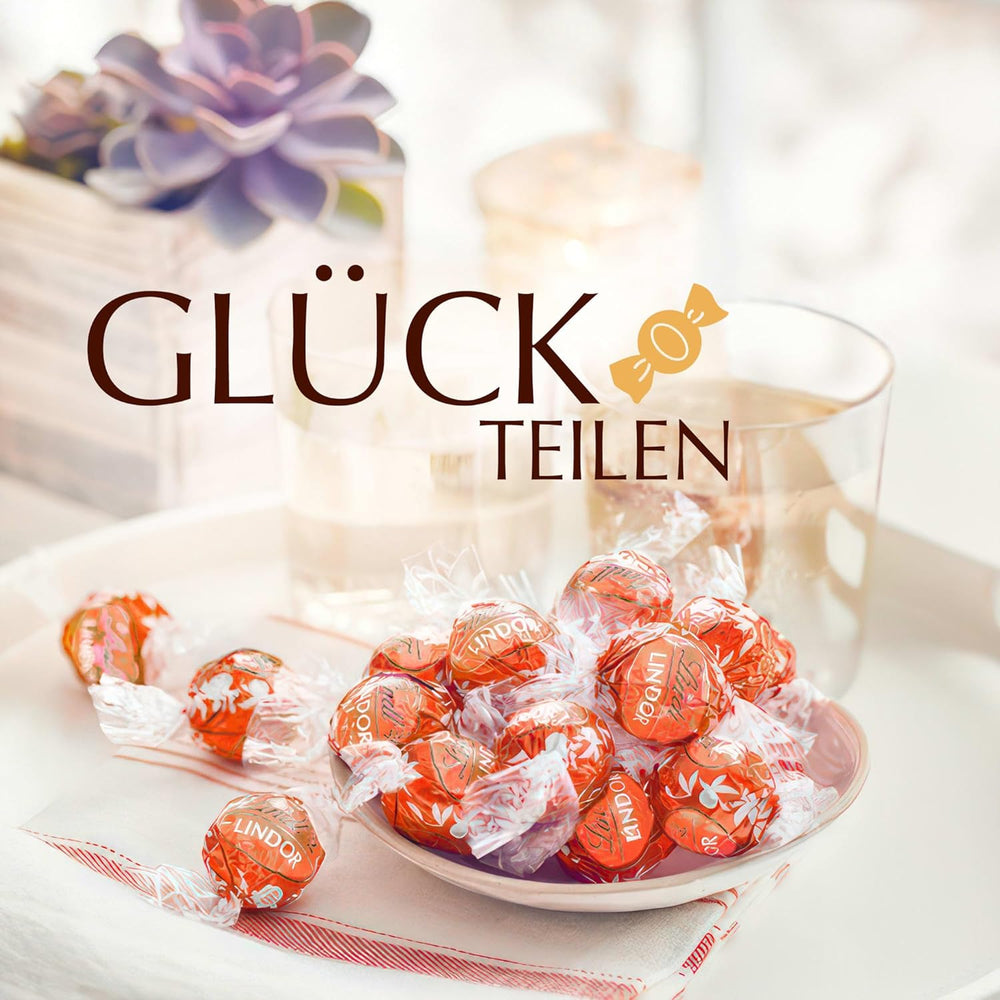 Lindt LINDOR Čokoládové kuličky červené oranžové | 1 kg uzavíratelný sáček | cca. 80 čokoládových bonbonů s náplní rozplývající se v ústech | Hromadné balení, čokoládový dárek